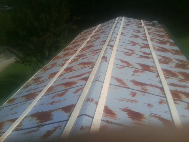 Rusted metal roof panels with new wood purlins before replacement — Storm Damage Roof Repair in Moss Landing by Roofing Brothers